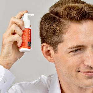 一名男性沿着发际线涂抹FOLIGAIN TRIOXIDIL外用护理产品